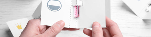 female hands holding perfume sample paper