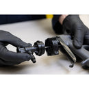 Operator connecting disposable 3M Water-Based Spray Nozzle to applicator system during setup.