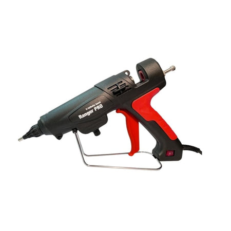 Black and red hot glue gun standing on table