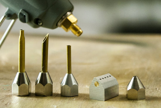 5 hot glue gun nozzles on table