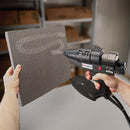 Power Adhesives Tec 6300 spray glue gun applying hot melt adhesive in a controlled spray pattern onto foam insulation material.