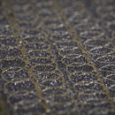 Close-up of hot melt adhesive spray pattern applied evenly across a textured foam surface.