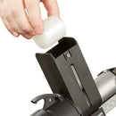 Loading a cylindrical hot melt adhesive slug into the open magazine of the Tec 7100 pneumatic glue gun from Power Adhesives.